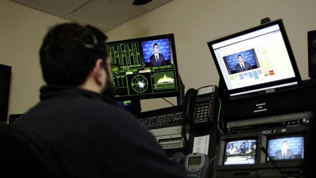 Staff member operating a studio remotely for live TV appearance